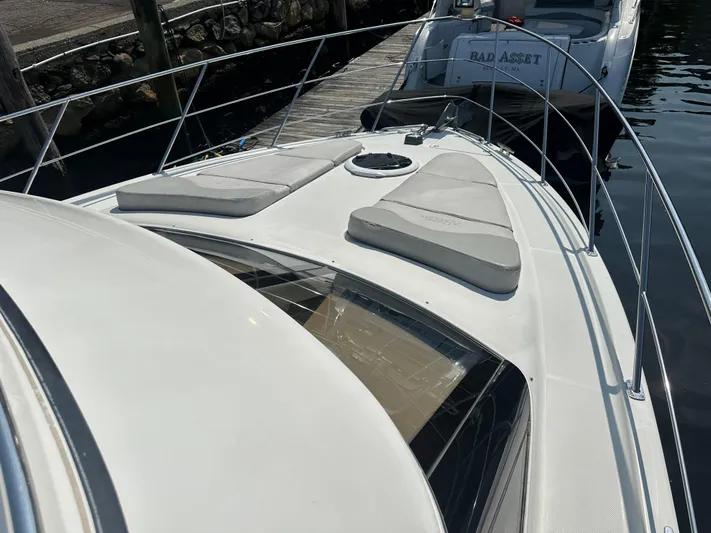  Yacht Photos Pics 2004 Carver 420 Mariner yacht with sun pads on deck, docked at marina.