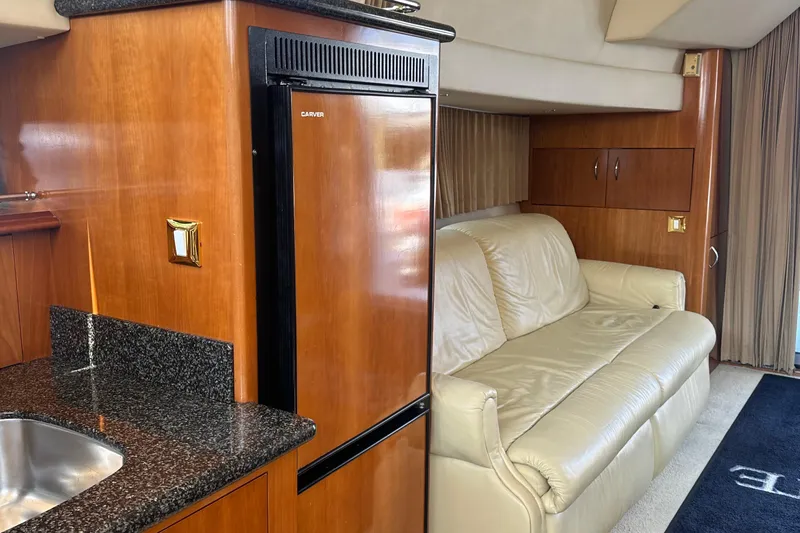  Yacht Photos Pics Interior of 2004 Carver 420 Mariner yacht with leather sofa and kitchenette.