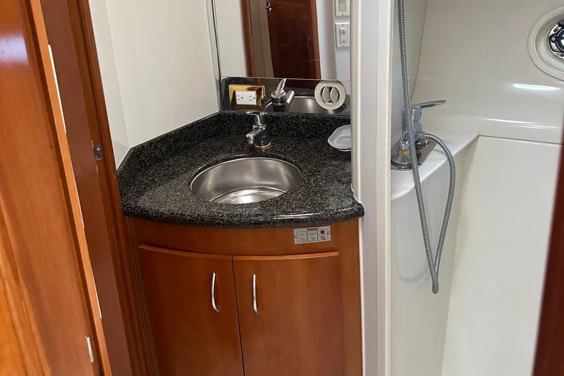  Yacht Photos Pics 2004 Carver 420 Mariner bathroom with sink, granite countertop, and shower.