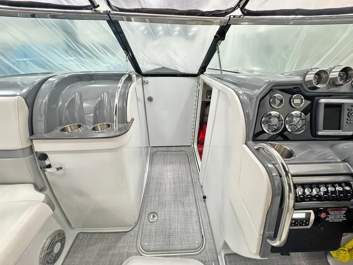  Yacht Photos Pics Interior of a 2013 Formula 290 Bowrider boat, featuring sleek dashboard and cup holders.