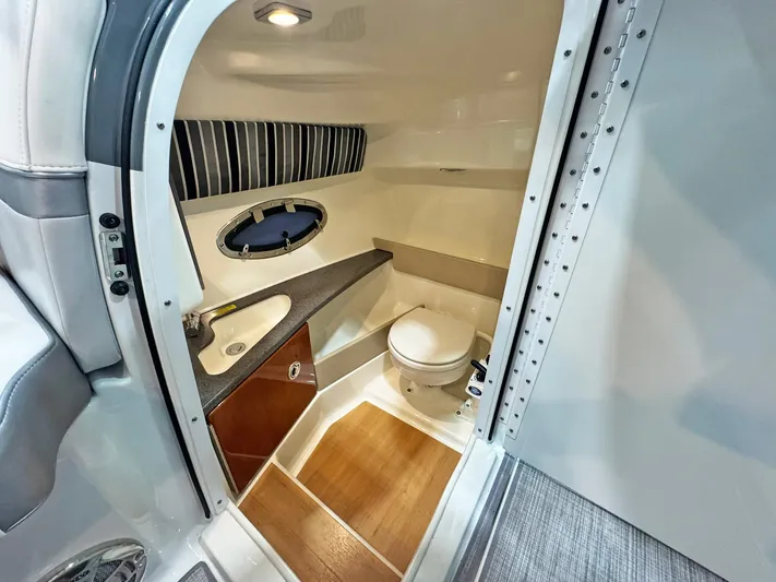  Yacht Photos Pics 2013 Formula 290 Bowrider bathroom with sink, toilet, and wood flooring.