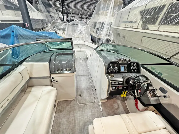  Yacht Photos Pics 2013 Formula 290 Bowrider interior with modern dashboard and seating in a covered storage area.