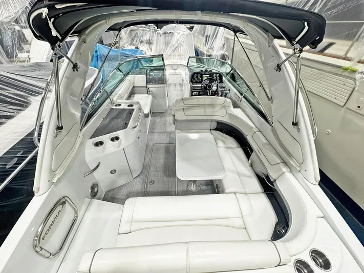  Yacht Photos Pics 2013 Formula 290 Bowrider interior with white seating and modern dashboard.