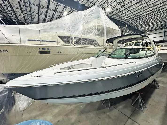  Yacht Photos Pics 2013 Formula 290 Bowrider boat in indoor storage, sleek design, elevated on stands.