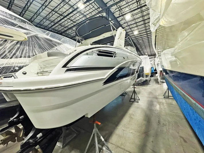  Yacht Photos Pics 2013 Formula 290 Bowrider in storage, sleek design, elevated on stands.