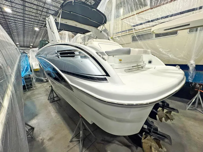  Yacht Photos Pics 2013 Formula 290 Bowrider in storage, showcasing sleek design and dual propellers.