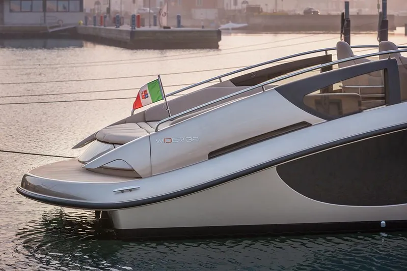  Yacht Photos Pics Luxury Wider 32 yacht from 2016 docked, featuring sleek design and Italian flag.