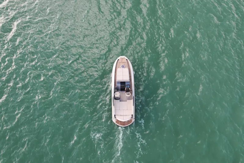  Yacht Photos Pics Aerial view of 2016 Wider 32 boat cruising on open water.