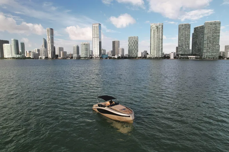  Yacht Photos Pics Luxury Wider 32 yacht on water with city skyline backdrop, 2016 model.