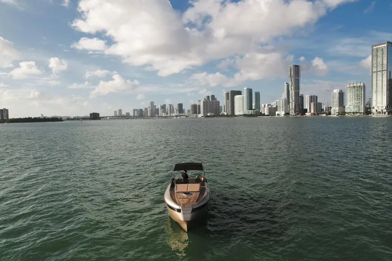  Yacht Photos Pics Boat on water with city skyline in background, Wider 32, 2016 model.