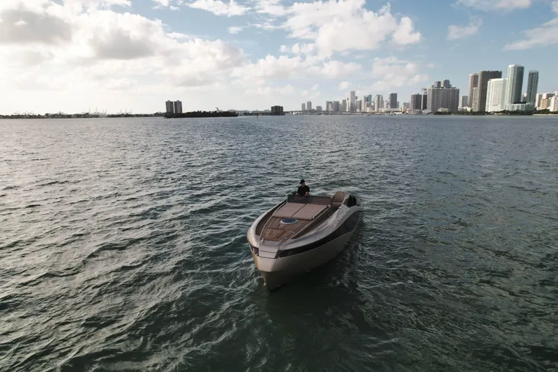  Yacht Photos Pics Luxury Wider 32 yacht on water with city skyline in the background, 2016 model.