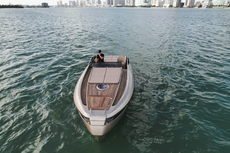  Yacht Photos Pics Luxury Wider 32 yacht cruising on open water, city skyline in background, 2016 model.
