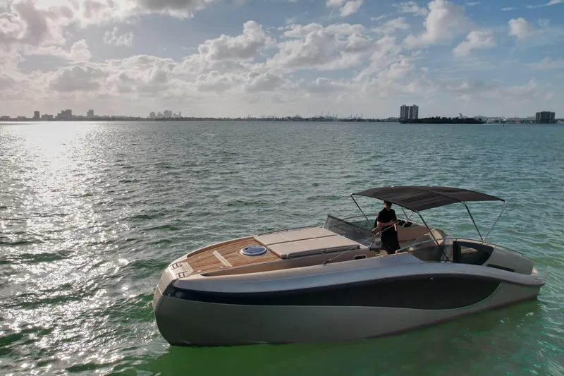  Yacht Photos Pics Luxury Wider 32 yacht cruising on calm waters under a partly cloudy sky.