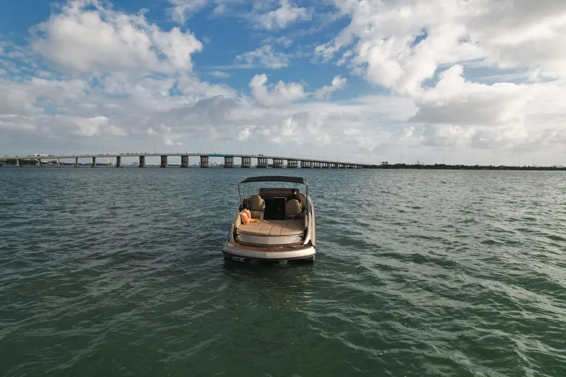  Yacht Photos Pics Wider 32 boat on open water with bridge in background, 2016 model.
