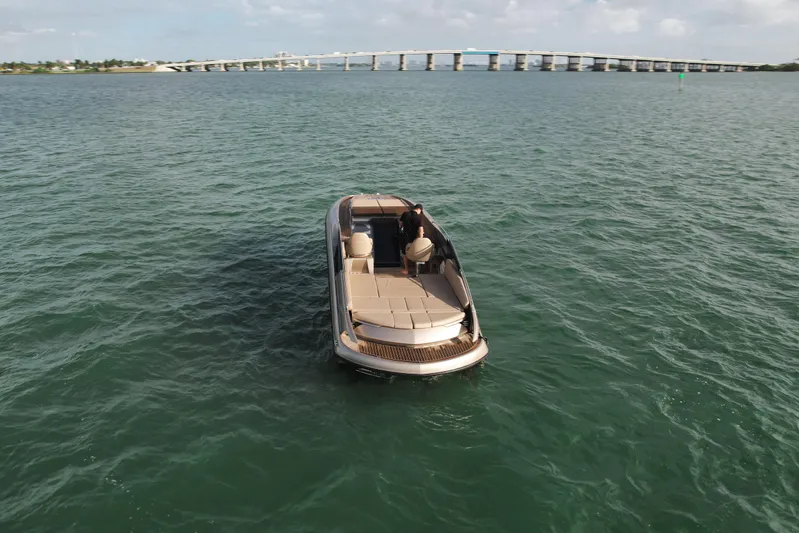  Yacht Photos Pics Wider 32 boat from 2016 on open water with bridge in background.