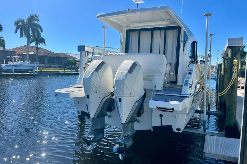  Yacht Photos Pics 2024 Beneteau Antares 11 docked with dual outboard engines, sunny waterfront view.