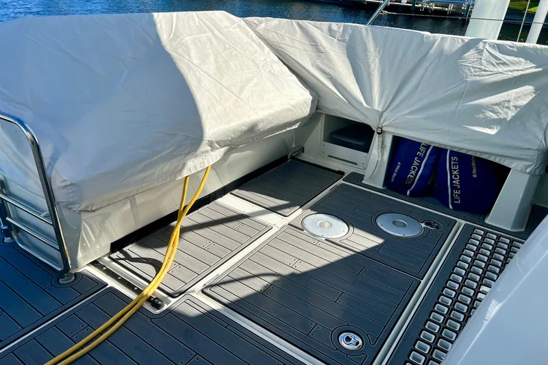  Yacht Photos Pics 2024 Beneteau Antares 11 deck with covered seating and life jackets.