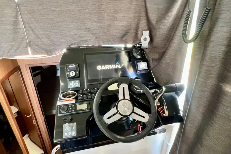  Yacht Photos Pics 2024 Beneteau Antares 11 helm with Garmin navigation system and modern controls.