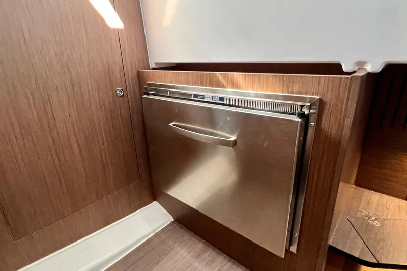  Yacht Photos Pics 2024 Beneteau Antares 11 interior with stainless steel appliance and wood paneling.