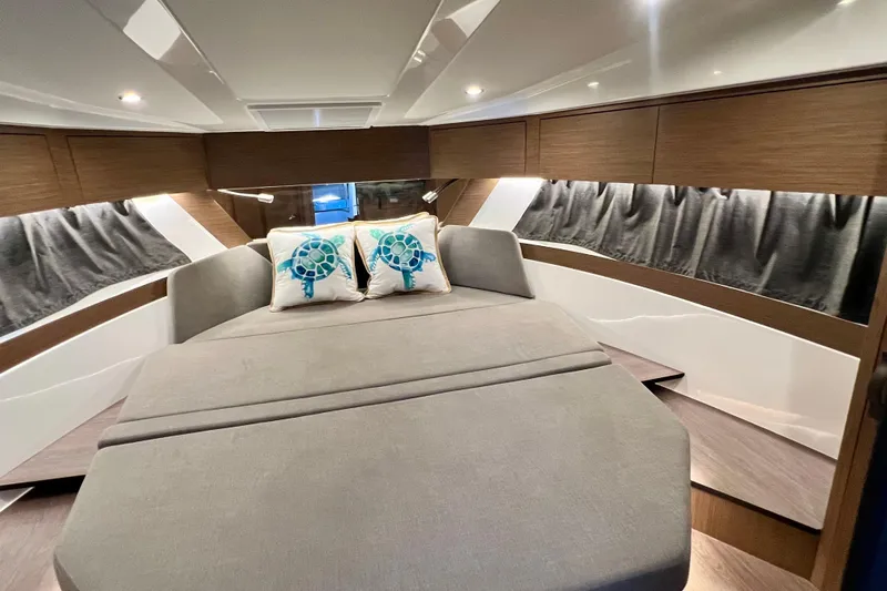  Yacht Photos Pics Luxurious interior of 2024 Beneteau Antares 11 with cozy bed and stylish decor.