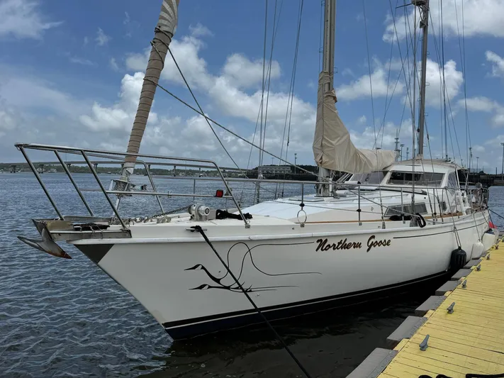 Northern Goose Yacht Photos Pics Sailboat "Northern Goose" docked, Amel Mango 52, 1980 model, under a partly cloudy sky.