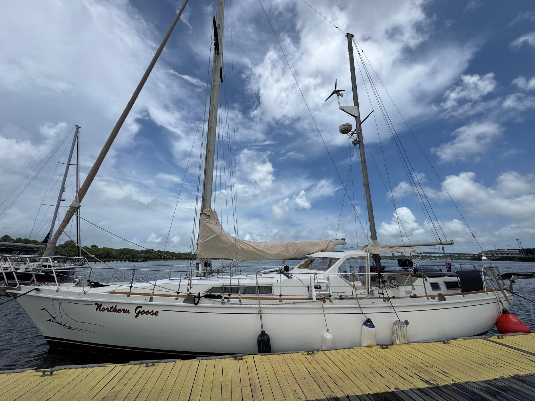 Sailboat "Northern Goose" docked, Amel Mango 52, 1980 model, under a partly cloudy sky.
