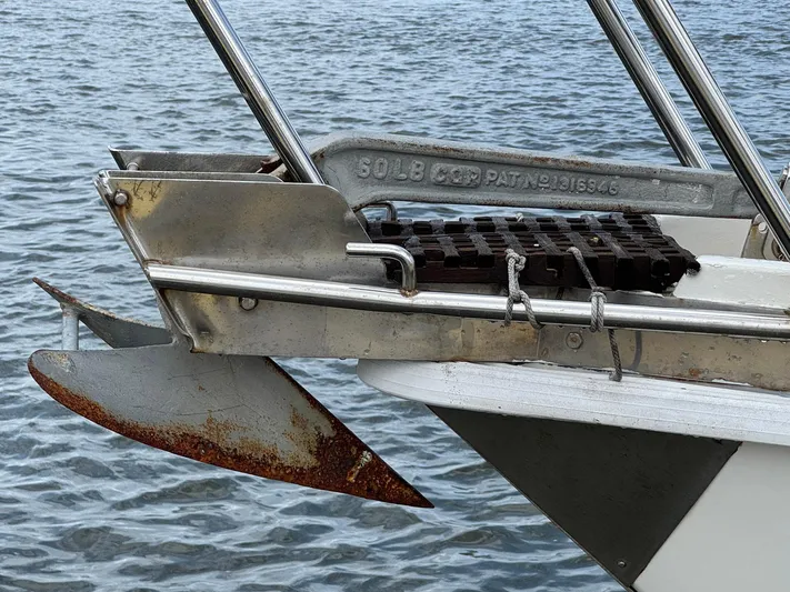 Northern Goose Yacht Photos Pics Rusty anchor on 1980 Amel Mango 52 sailboat against water background.
