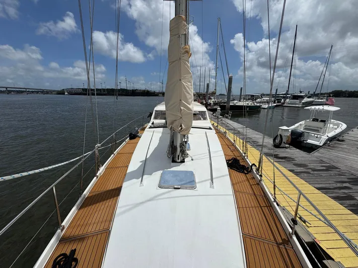 Northern Goose Yacht Photos Pics 1980 Amel Mango 52 sailboat docked at marina under cloudy sky.