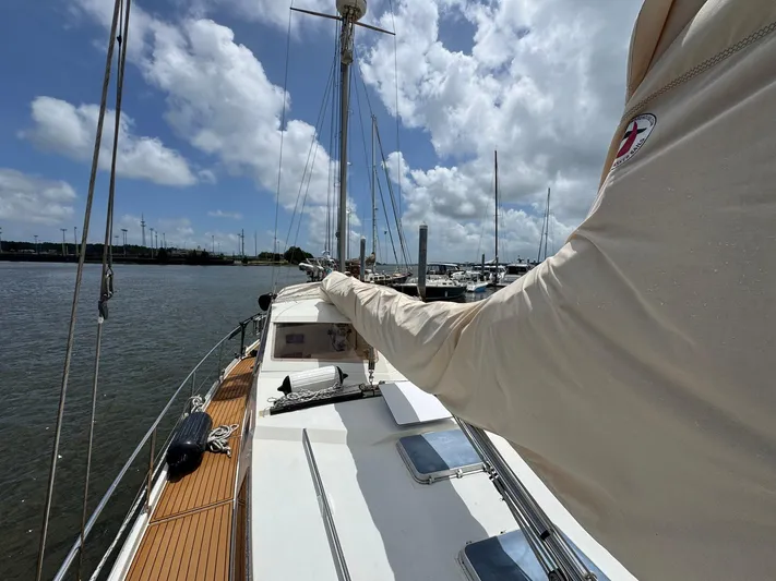 Northern Goose Yacht Photos Pics 1980 Amel Mango 52 sailboat docked under a partly cloudy sky.
