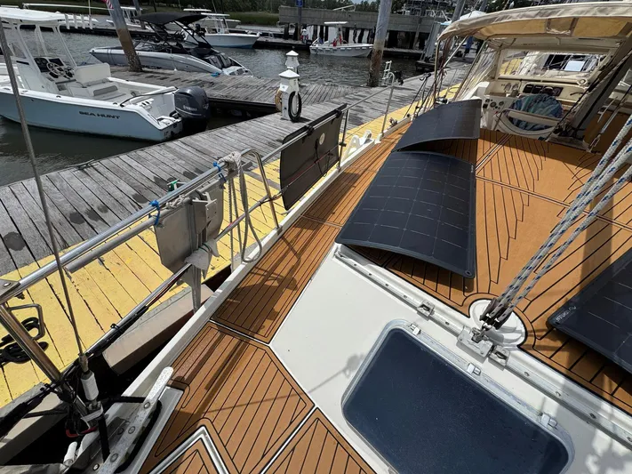 Northern Goose Yacht Photos Pics 1980 Amel Mango 52 sailboat with solar panels docked at marina.