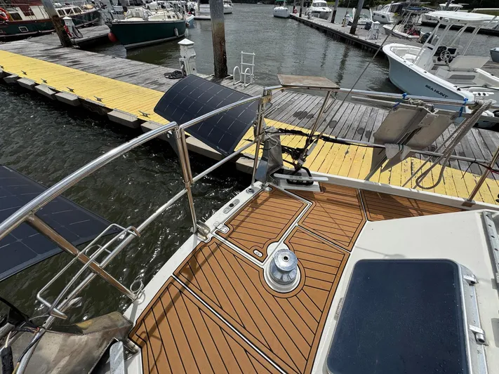 Northern Goose Yacht Photos Pics 1980 Amel Mango 52 sailboat deck with solar panels at marina dock.