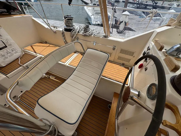 Northern Goose Yacht Photos Pics Cockpit of 1980 Amel Mango 52 sailboat with wooden flooring and cushioned seating.