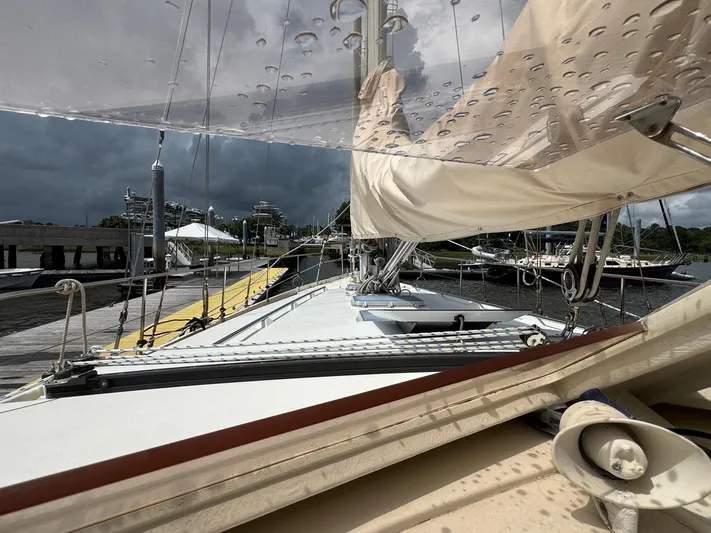 Northern Goose Yacht Photos Pics Sailboat Amel Mango 52 docked, cloudy sky, wet deck, marina view, 1980 model.