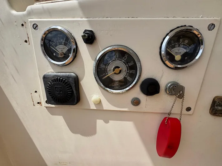 Northern Goose Yacht Photos Pics Control panel of a 1980 Amel Mango 52 sailboat with gauges and keychain.