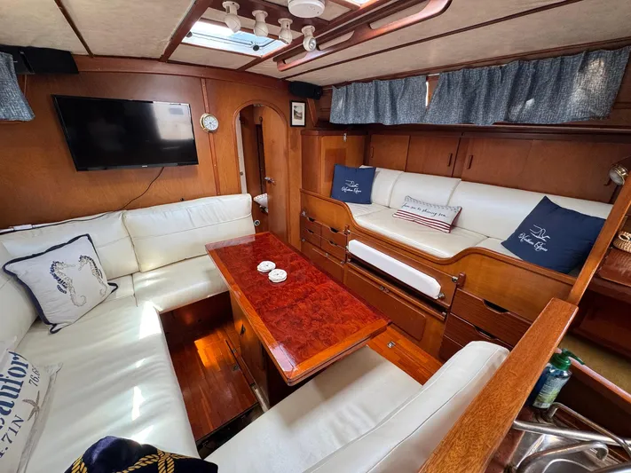 Northern Goose Yacht Photos Pics Interior of 1980 Amel Mango 52 yacht with cozy seating and wooden finishes.
