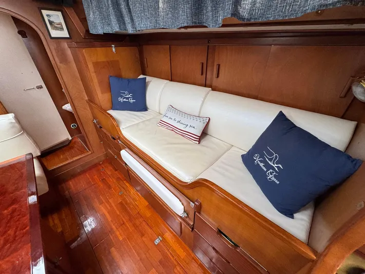 Northern Goose Yacht Photos Pics Interior of 1980 Amel Mango 52 yacht with wooden finish and cozy seating area.