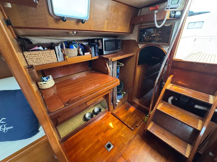 Northern Goose Yacht Photos Pics Interior of 1980 Amel Mango 52 sailboat with wooden furnishings and storage.