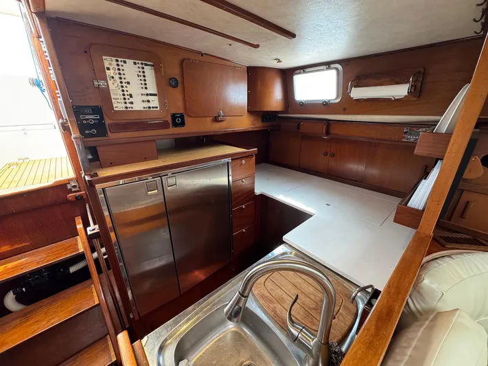 Northern Goose Yacht Photos Pics Interior of 1980 Amel Mango 52 yacht with wooden cabinetry and stainless steel appliances.