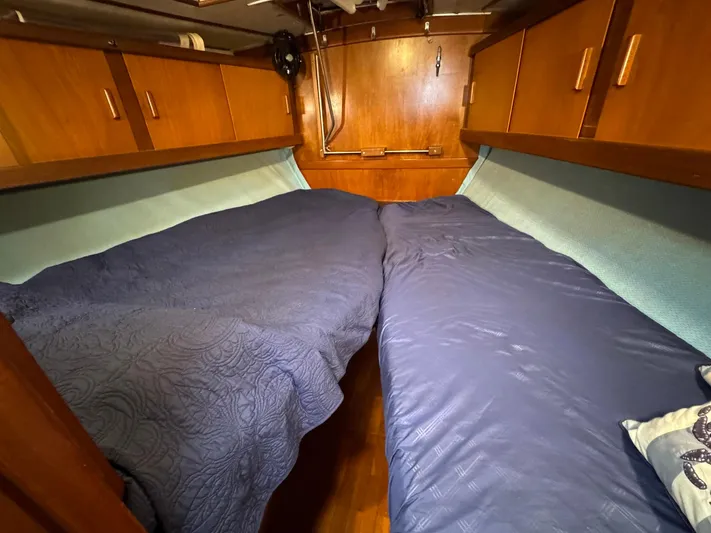 Northern Goose Yacht Photos Pics Cozy cabin interior of 1980 Amel Mango 52 sailboat with twin beds and wooden cabinetry.