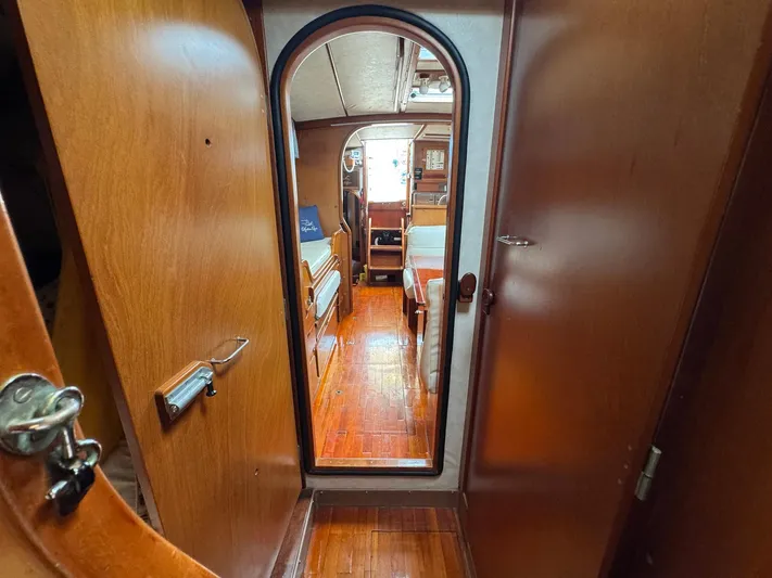 Northern Goose Yacht Photos Pics Interior view of 1980 Amel Mango 52 sailboat, featuring wooden cabin and cozy seating area.