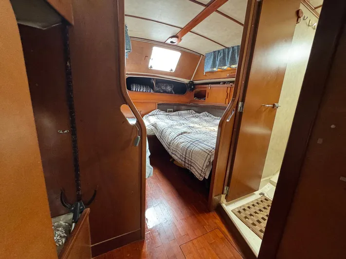 Northern Goose Yacht Photos Pics Cozy cabin interior of 1980 Amel Mango 52 sailboat with wooden furnishings.