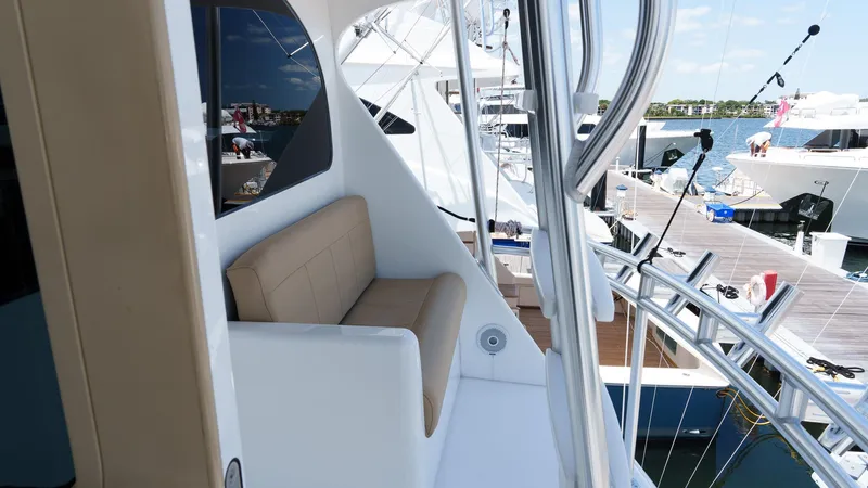 Benedetta Yacht Photos Pics 2012 Viking 70 Enclosed Bridge yacht with beige seating, docked at a marina.