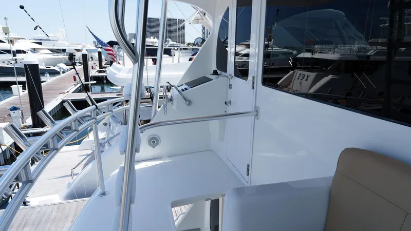 Benedetta Yacht Photos Pics 2012 Viking 70 Enclosed Bridge yacht docked at marina, showcasing sleek design and modern features.