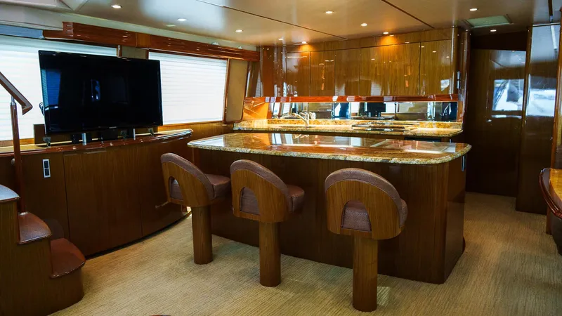 Benedetta Yacht Photos Pics Luxurious interior of 2012 Viking 70 Enclosed Bridge yacht with elegant wood finishes.