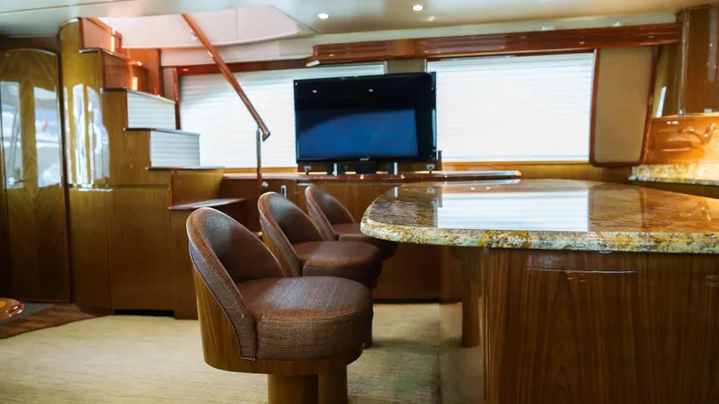 Benedetta Yacht Photos Pics Luxurious interior of 2012 Viking 70 Enclosed Bridge yacht with elegant seating and granite countertop.