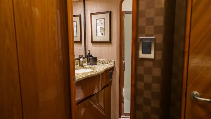 Benedetta Yacht Photos Pics Luxurious bathroom interior on 2012 Viking 70 Enclosed Bridge yacht, featuring elegant wood and granite finishes.