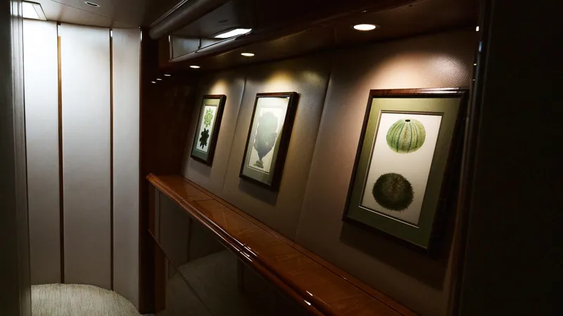 Benedetta Yacht Photos Pics Interior hallway of 2012 Viking 70 Enclosed Bridge yacht with framed artwork and recessed lighting.