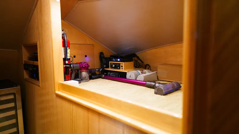 Benedetta Yacht Photos Pics Interior storage area of 2012 Viking 70 Enclosed Bridge yacht with cleaning equipment.