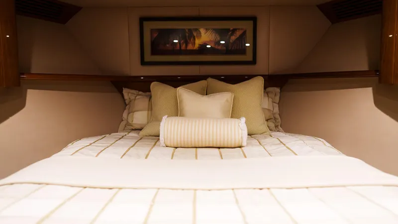 Benedetta Yacht Photos Pics Luxurious bedroom interior of 2012 Viking 70 Enclosed Bridge yacht with elegant bedding.