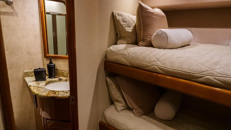 Benedetta Yacht Photos Pics Bunk beds and vanity in 2012 Viking 70 Enclosed Bridge yacht interior.